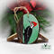 A hand-painted pileated woodpecker on a wood slice Christmas ornament available at Cove Creek Photography.